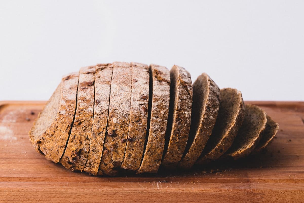 Rustic sourdough batard loaf on wooden board